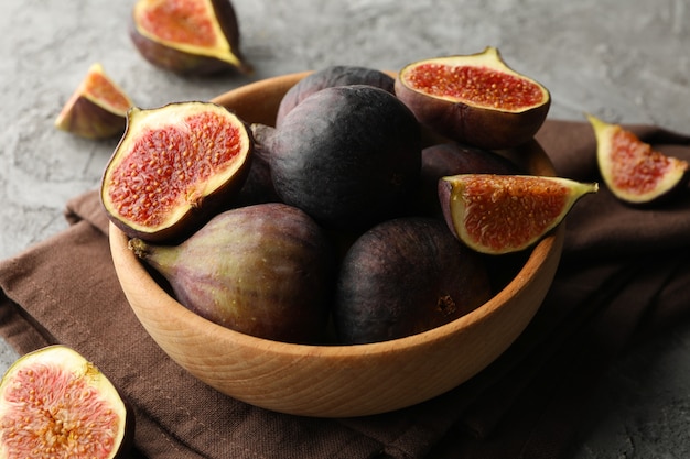 Towel and bowl with fig on gray, close up