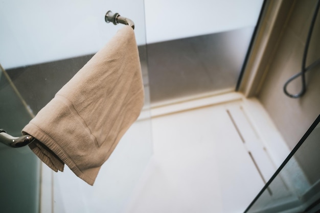 Towel hanging on a handle of a shower tray door