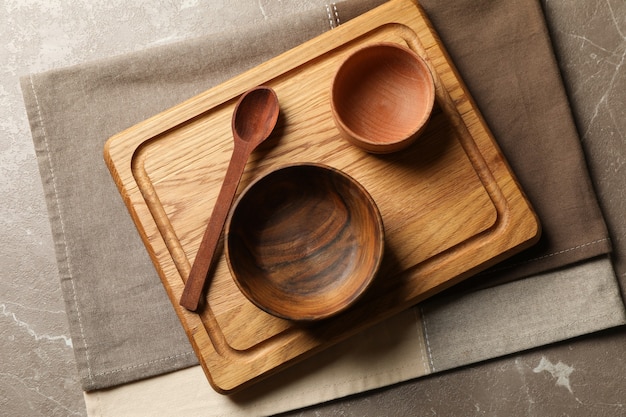 Towel with wooden kitchenware on gray table