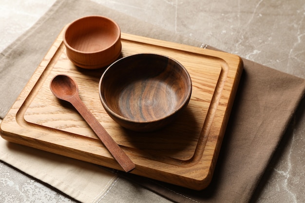 Towel with wooden kitchenware on gray table