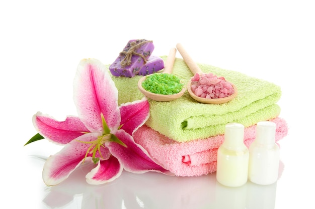 Towels with lily aroma oil soap and sea salt isolated on white