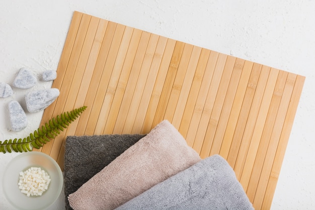 Towels on wooden mat with rocks