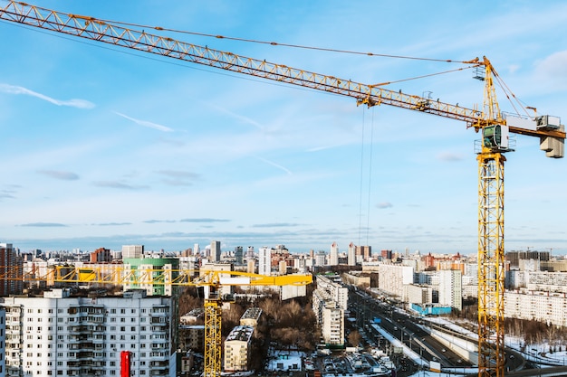 Tower construction crane on the background of construction