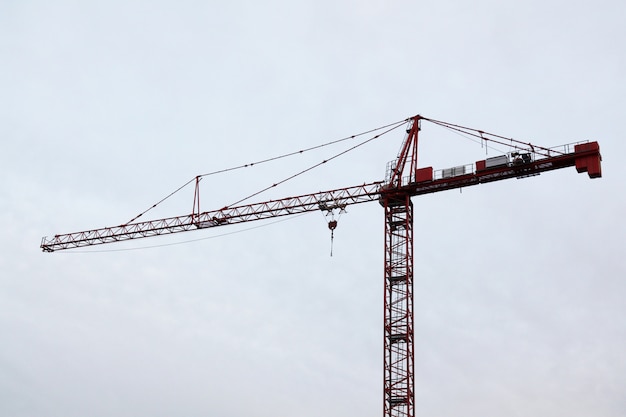 Tower construction cranes in white sky