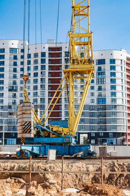 A tower crane assembles gutter panels during the construction of a panel house Modern housing construction Industrial engineering Construction of mortgage housing