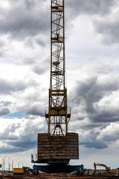 Tower crane closeup against the background of the cloudy sky Modern building technologies