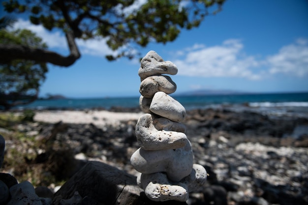 Tower of stones on sea beach background. Relaxing in the tropical beach, with stack of stones.