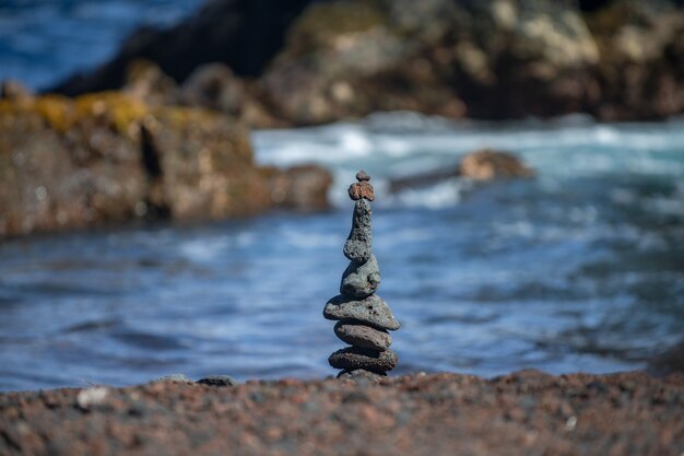 Tower of stones on sea beach background. Relaxing in the tropical beach, with stack of stones.