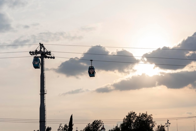 Tower with two teleferico or cablebus cabins in Mexico City with the sky in the background