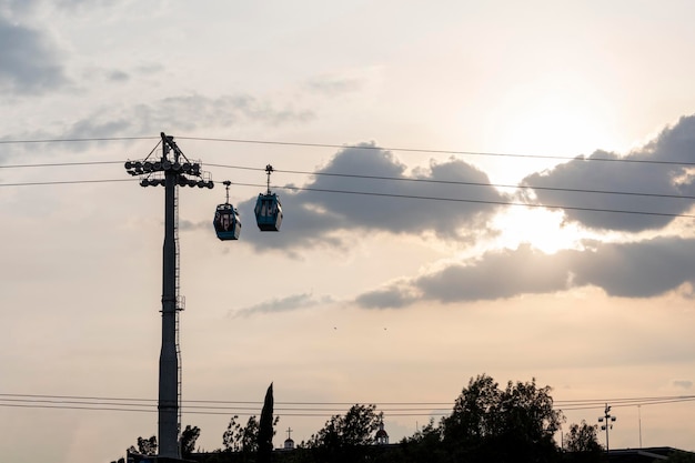 Tower with two teleferico or cablebus cabins in Mexico City with the sky in the background