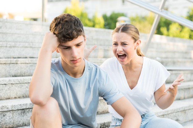 Toxic teenager girlfriend shouting at boyfriend