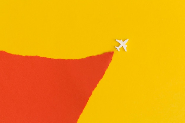 Toy airplane on a yellow background. Top view. Flat lay.