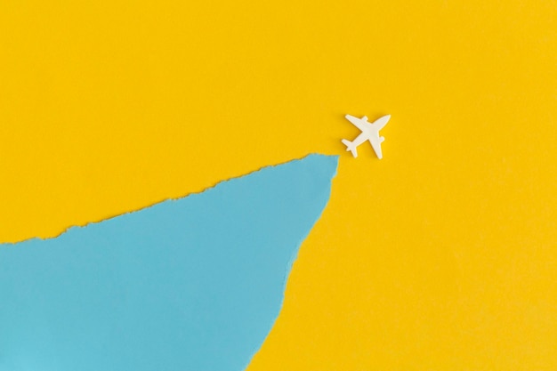 Toy airplane on a yellow background. Top view. Flat lay.