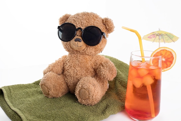 A toy brown bear enjoys a vacation in sunglasses