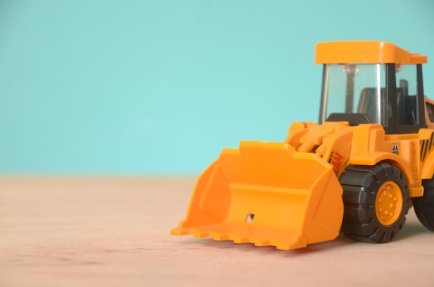 Photo the toy bulldozer with its bright yellow color and sturdy build symbolizes the power and productivity associated with construction and heavy machinery