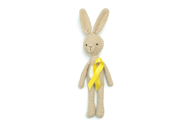 Toy bunny with child cancer awareness ribbon, isolated on white