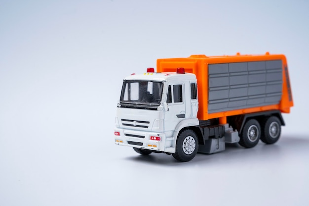 Toy car garbage truck with orange body on a white background