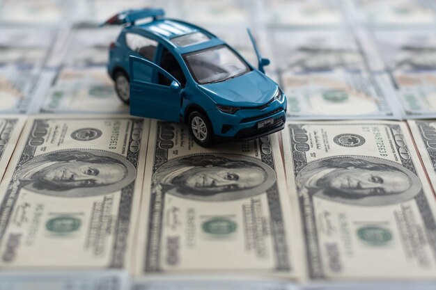 Toy car on one hundred dollar bills.