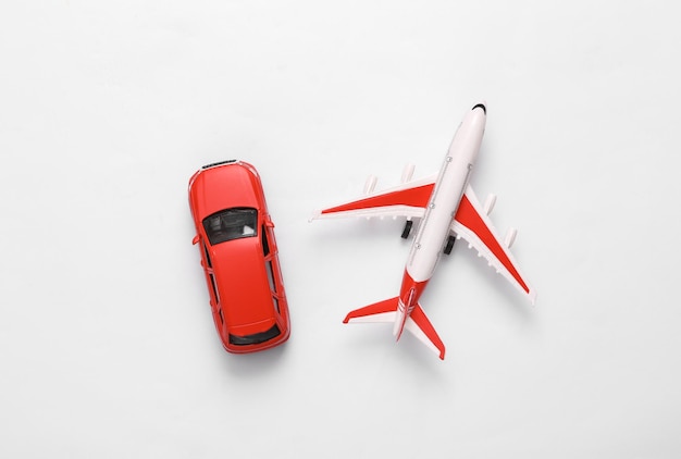 Photo toy car with air plane on white background travel concept top view