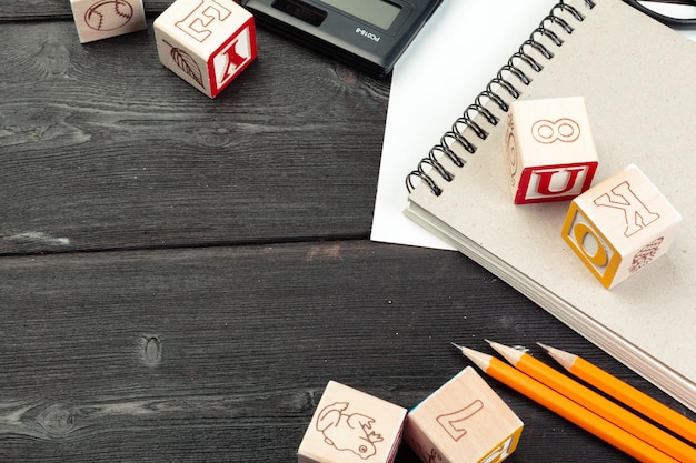 Toy cubes with letters on wooden surface 