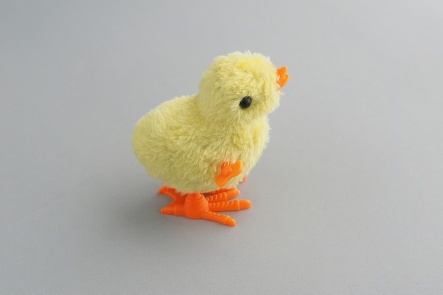 Toy groovy chicken on a gray background.