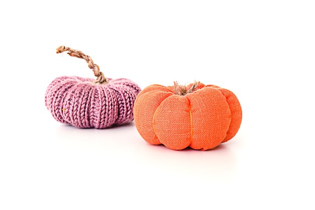 Toy knitted purple and orange miniature pumpkin isolated