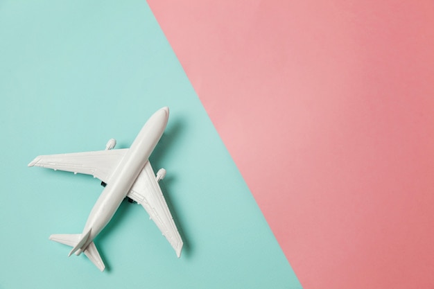 Toy plane on colorful pink and blue background