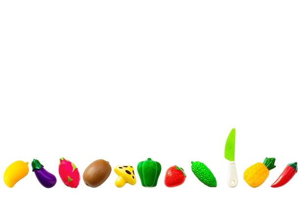 Toy plastic fruits and vegetable collection set isolated on white background. Plastic fruit for the game. Playing at the kids store.