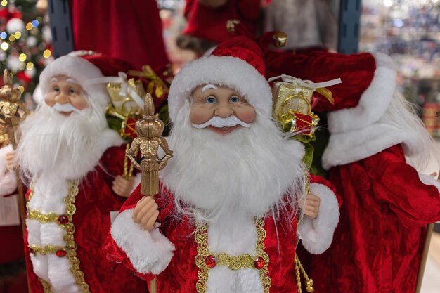 Toy Santa Clauses on the background of garlands Christmas decorations in market