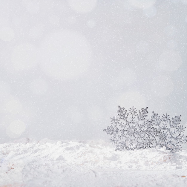 Toy snowflakes on bank of snow