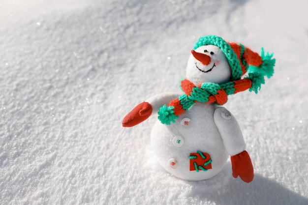 Toy snowman on sunny frosty day. Winter vacation