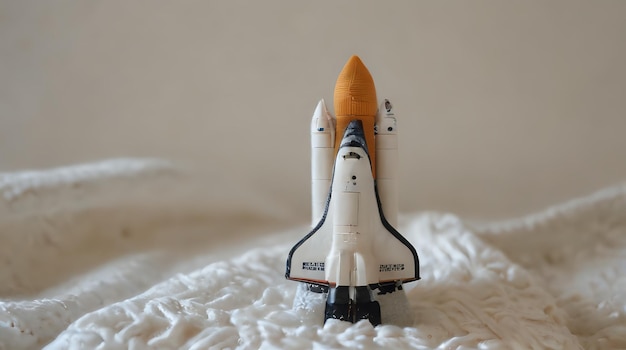 a toy space shuttle sitting on a bed