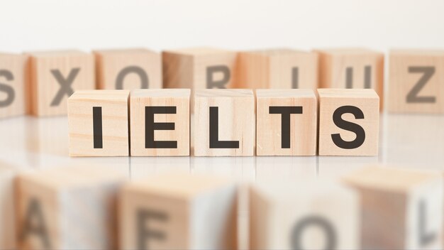 Toy wood blocks with letters IELTS on a table. IELTS - short for International English Language Testing System.