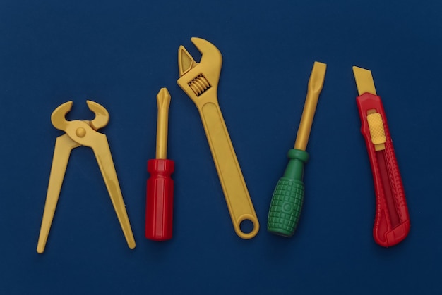 Toy work tools on a classic blue background. Color 2020