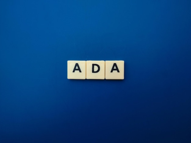 Toys word with the word ADA on blue background