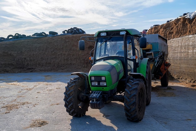 Tracror with attached forage cutting machine for animals