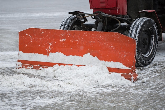 Tractor cleaning the road from the snow Excavator cleans the streets of large amounts of snow