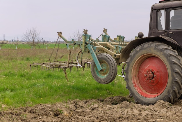 Tractor cultivates and milling soil on field