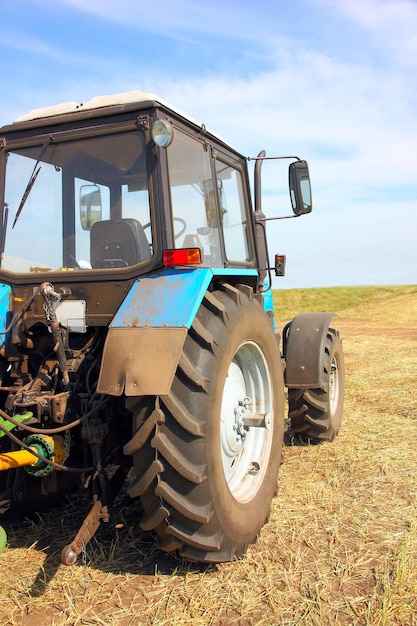 Tractor in a field agricultural scene in summer