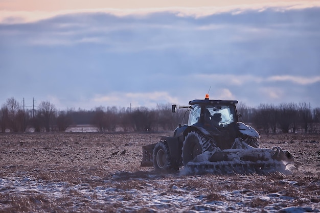 tractor in the field arable land winter agribusiness landscape seasonal work in a snowy field