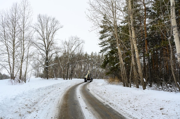 The tractor is driving on a snowy road Snow removal on city streets