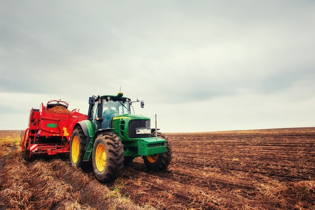 Tractor plowing farm field in preparation for spring planting