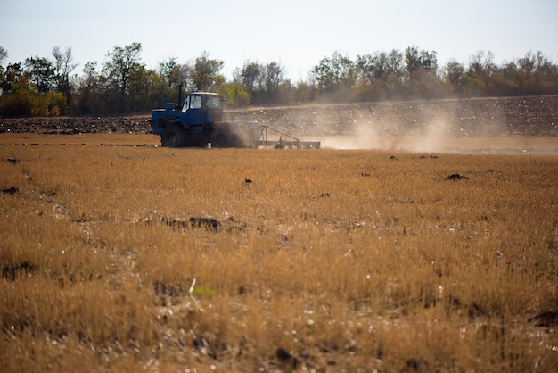 Tractor plowing fields preparing land for sowing