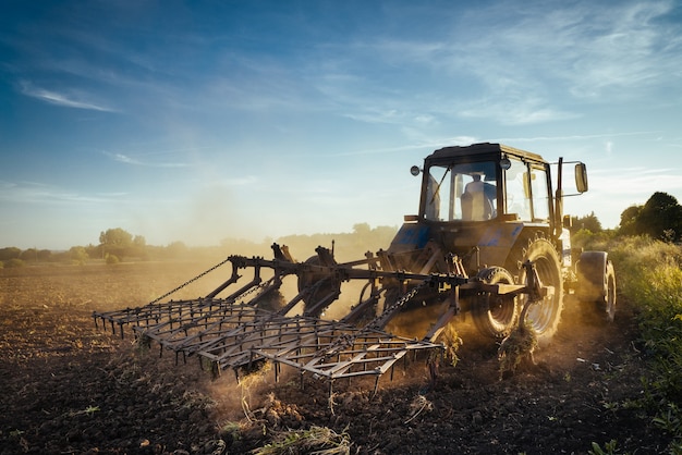 The tractor plows the land. Agriculture image