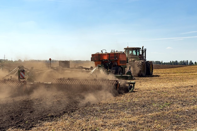 The tractor plows the land agriculture image