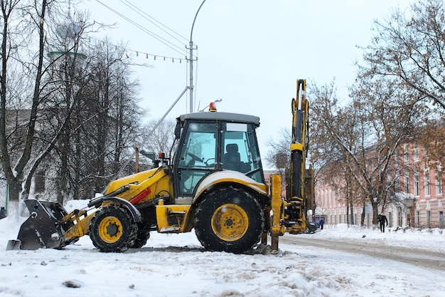 Tractor for snow removal is parked on a city street after work