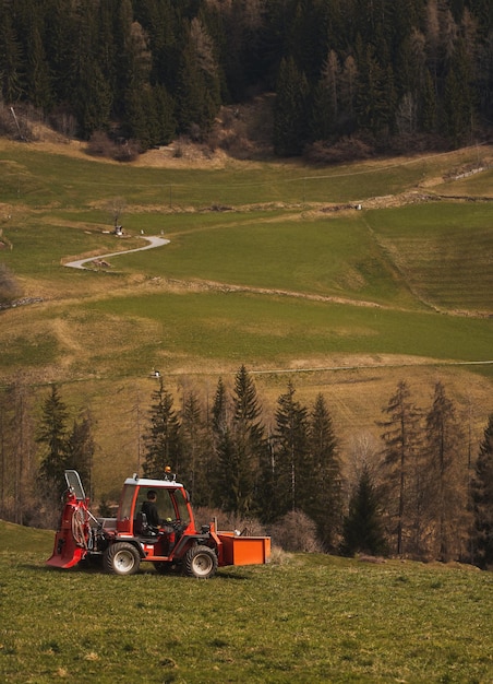 Tractor spraying pesticides on the field with a sprayer in spring agricultural fields in spring concept of rural farm countryside