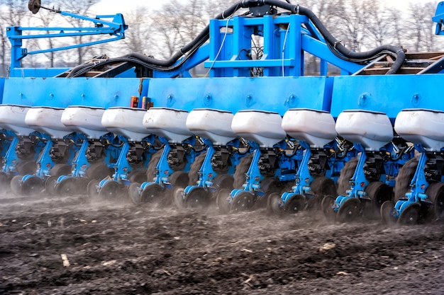 Tractor with aggregate working the soil close up