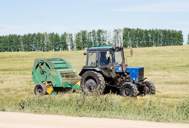 Tractor with trailed stacker, haymaking