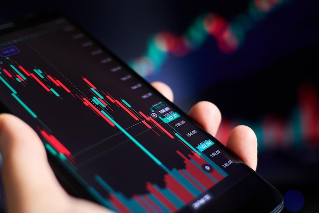 Trader analyzes stock market data in smartphone